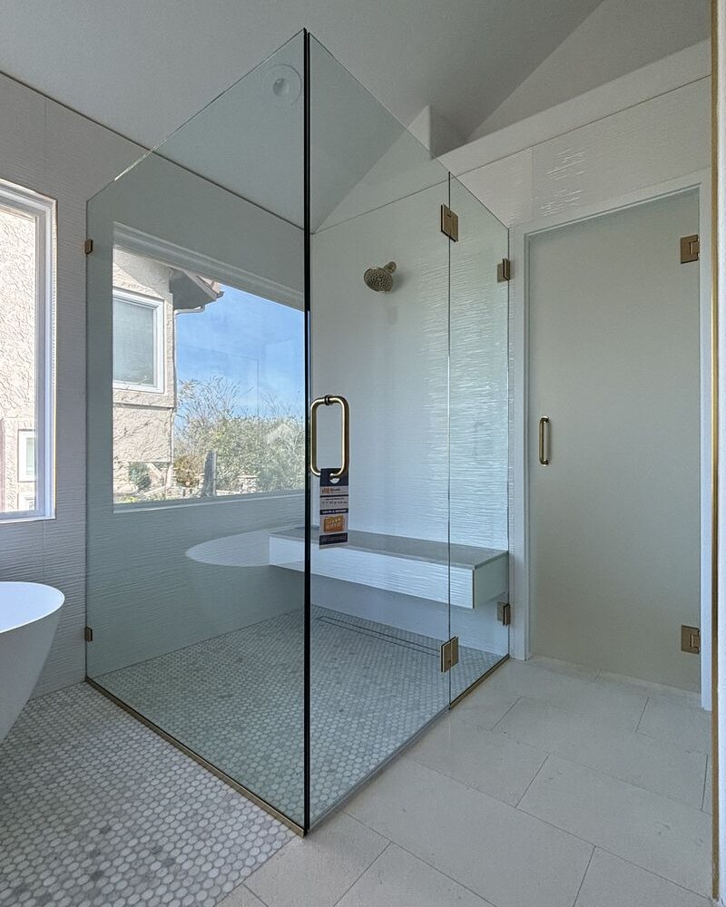 Curbless frameless corner shower with satin brass hardware in Rancho Peñasquitos, San Diego, CA